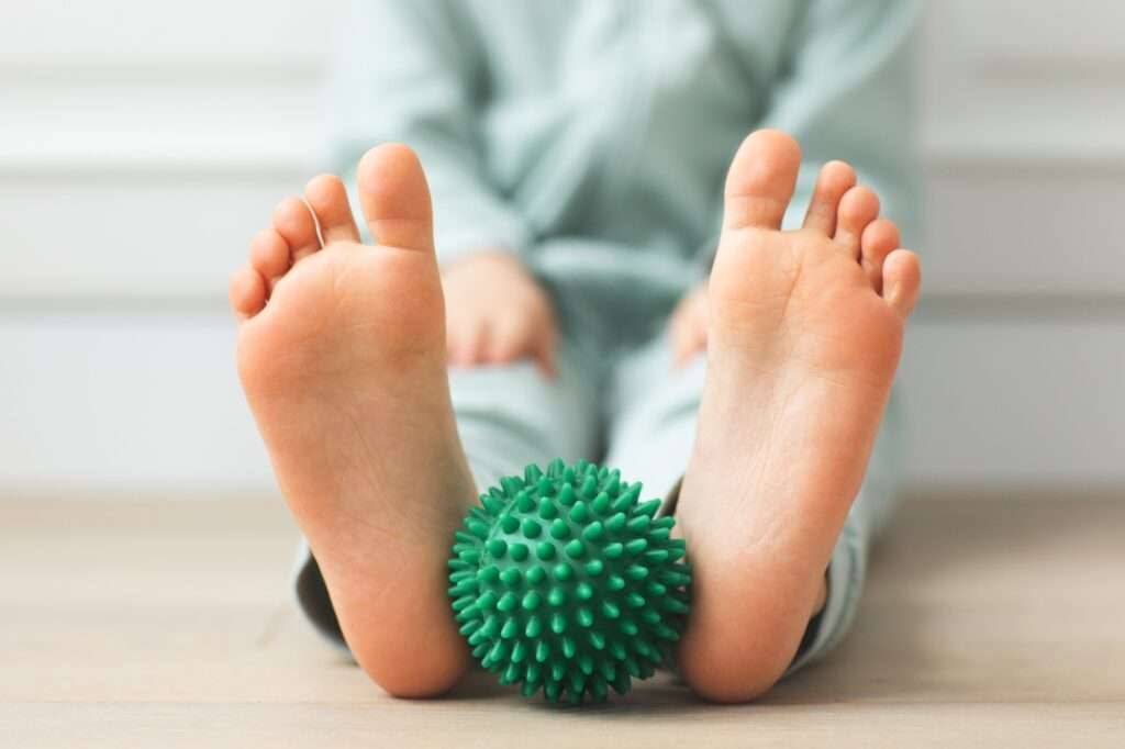 kid holding massage ball physical therapy and massage for development neuro psychology