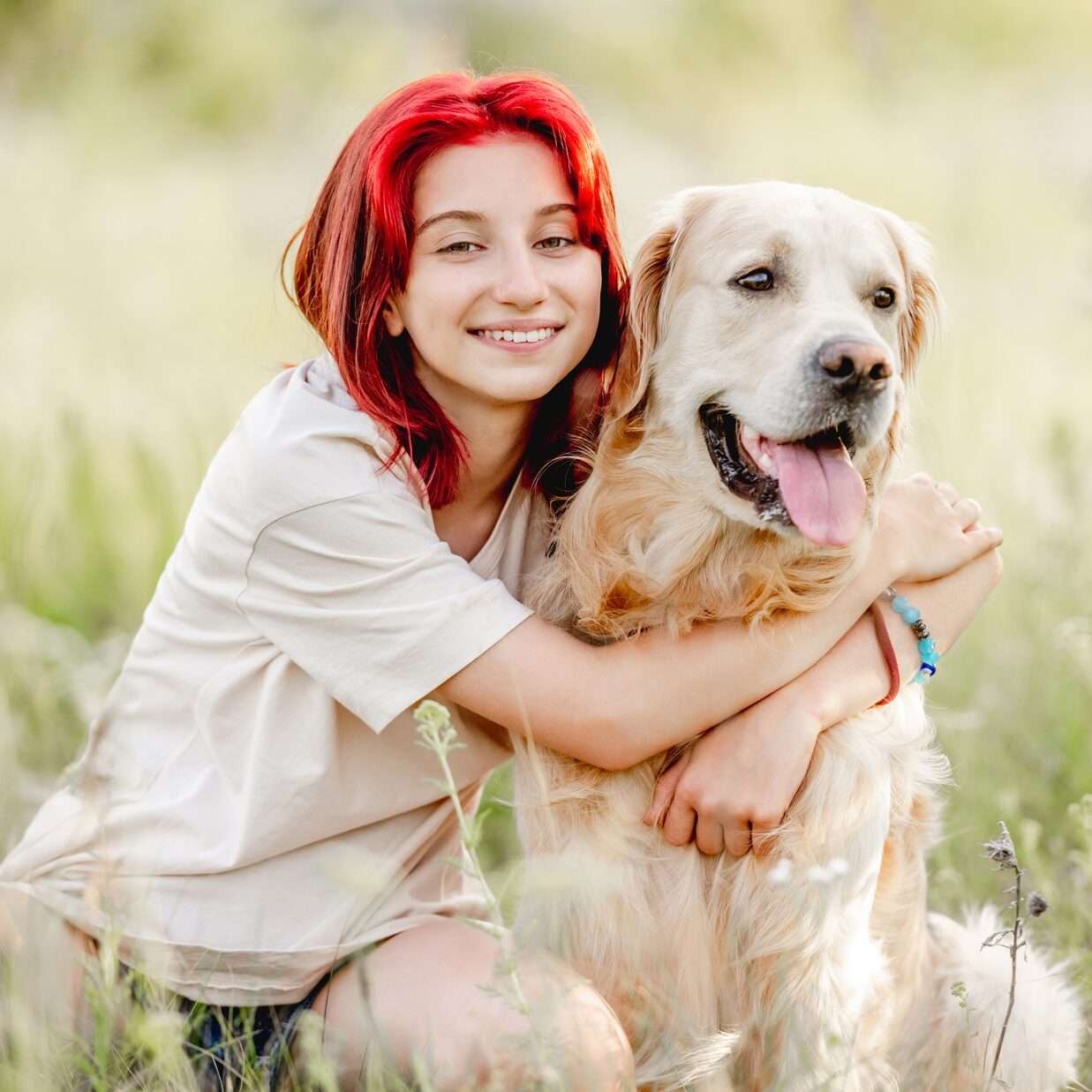 Teen girl with golden retriever dog